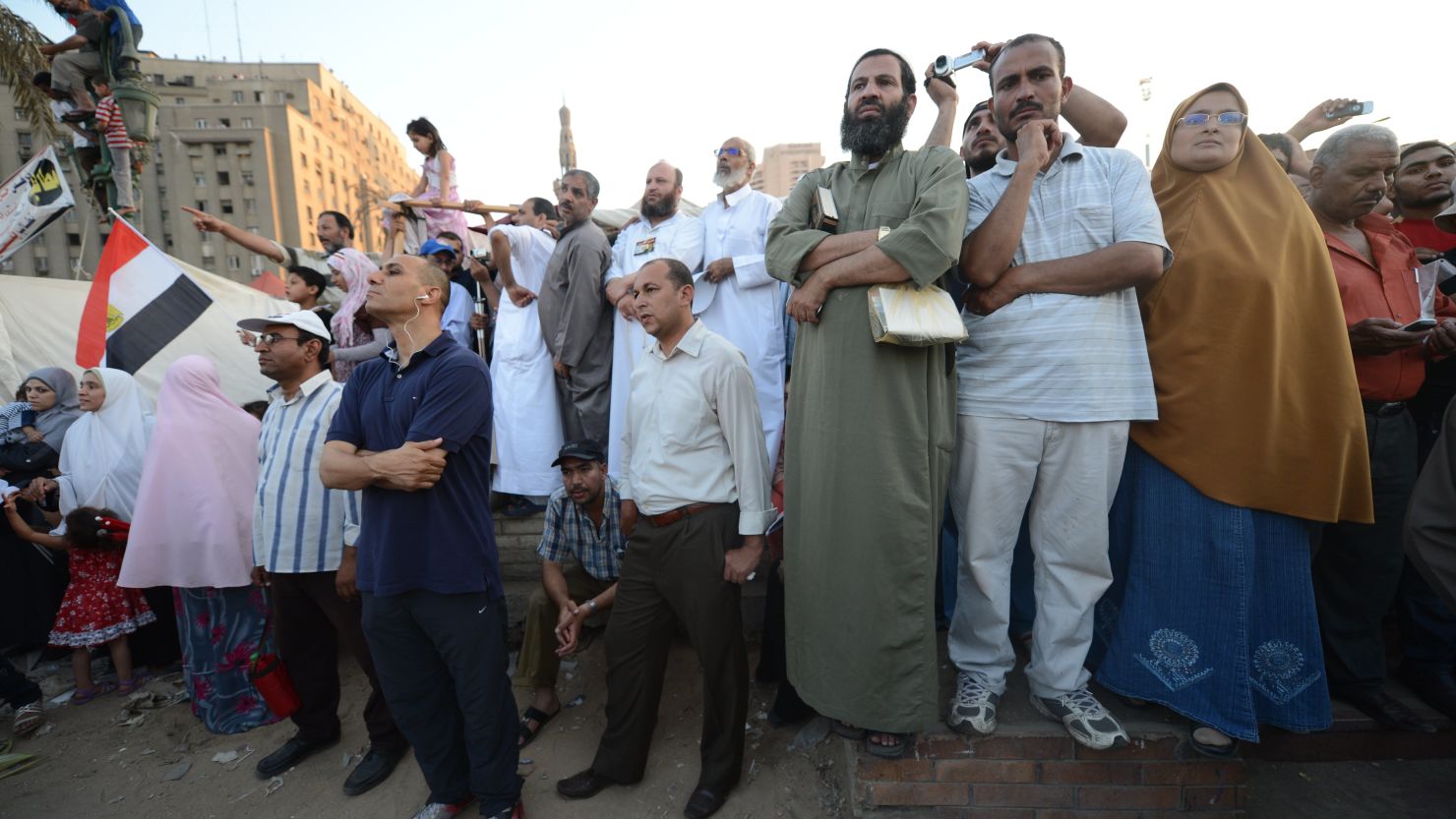 Egyptians in Cairo's Tahrir Square listen to a speech from President-elect Mohamed Morsi on Friday.