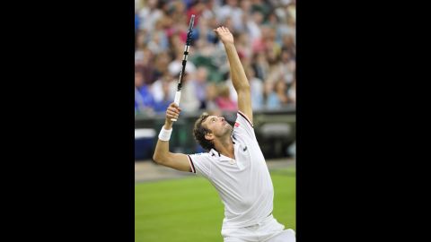 Julien Benneteau serves during his third-round men's singles match against Roger Federer on Friday.