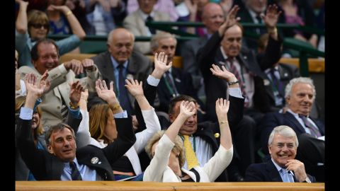 People in the Royal Box at the All-England Club take part in a "wave" on Friday.