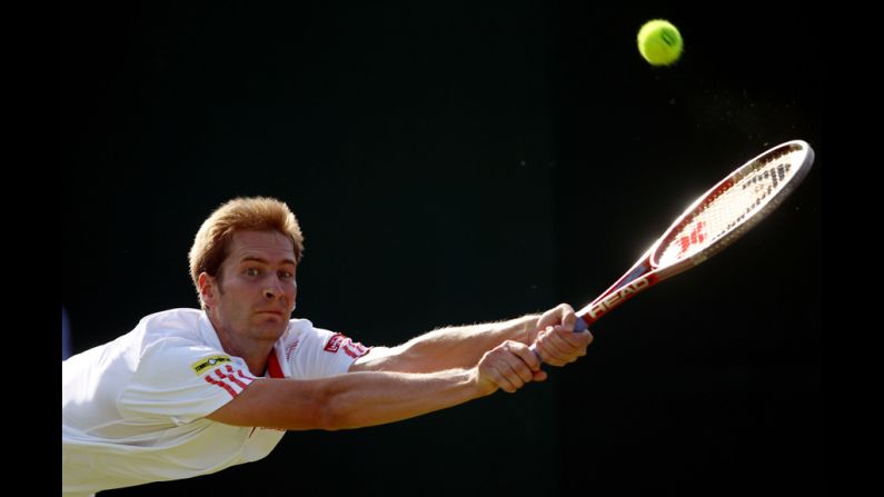 Florian Mayer of Germany hits a backhand return during his third-round match against Jerzy Janowicz of Poland on Friday.