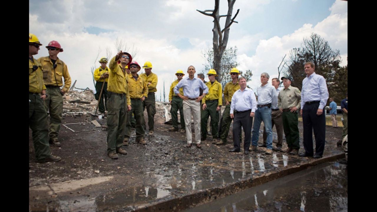President Barack Obama tours fire damage with elected officials and firefighters in the Mountain Shadows residential neighborhood in Colorado Springs on Friday.  