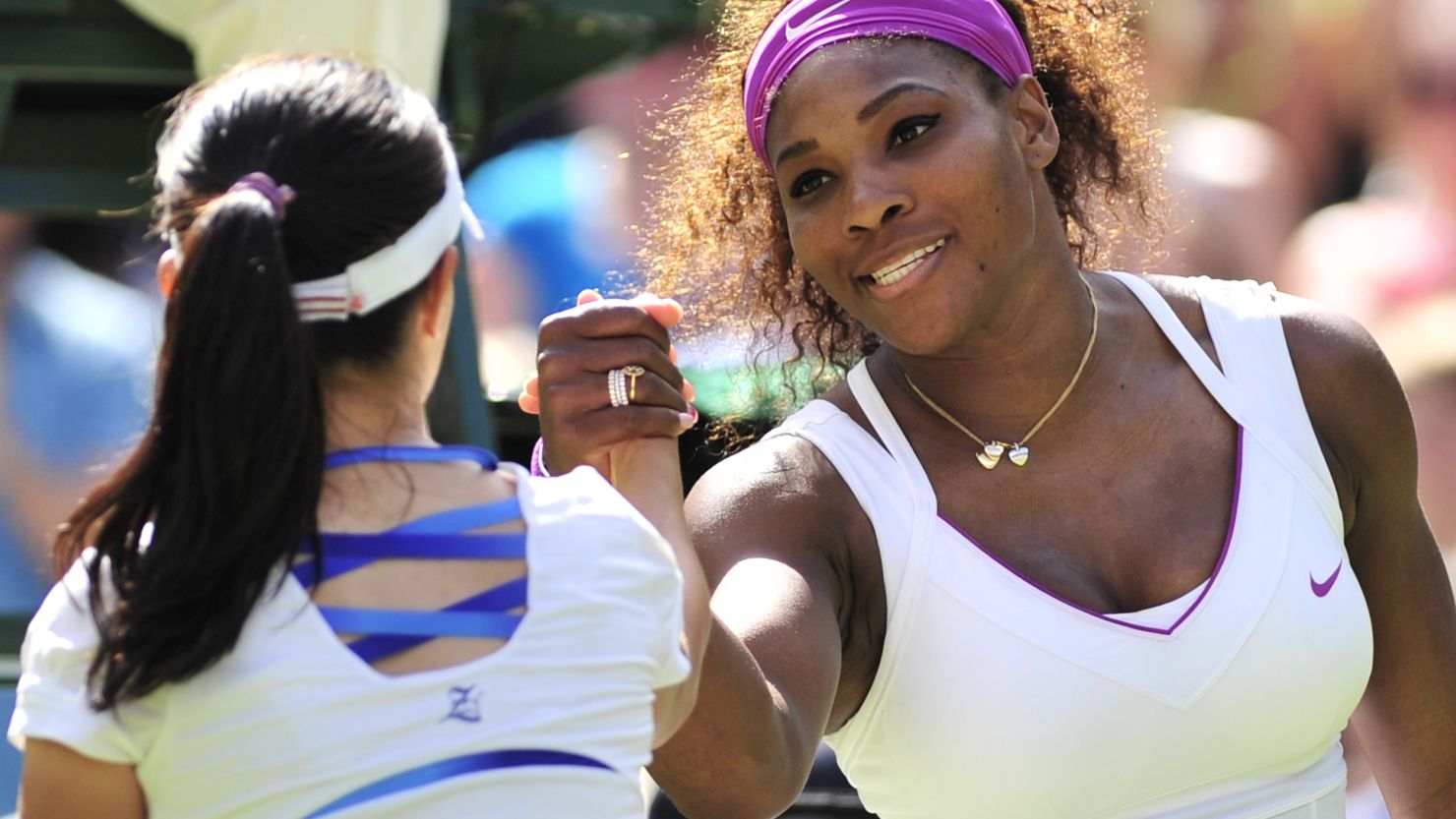 Serena Williams shakes hands with Zheng Jie of China after her three set victory at Wimbledon.