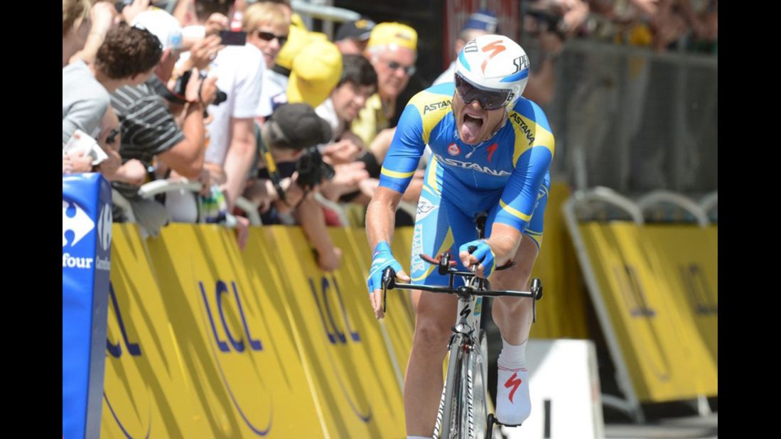 Andriy Grivko of Ukraine grimaces as he nears the finish line during the time trial, cheered on by fans.