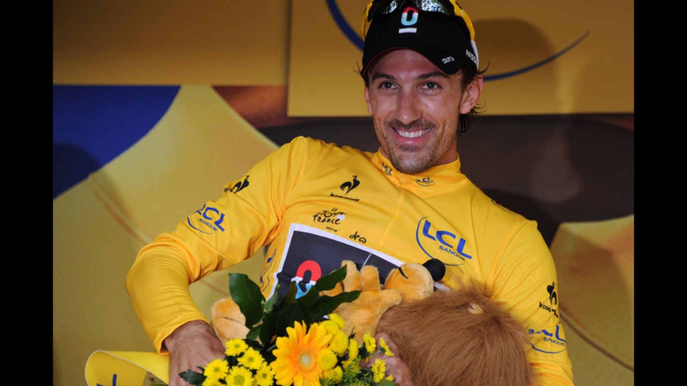 Cancellara celebrates on the podium Saturday and pulls on the yellow jersey, worn by the overall race leader. 