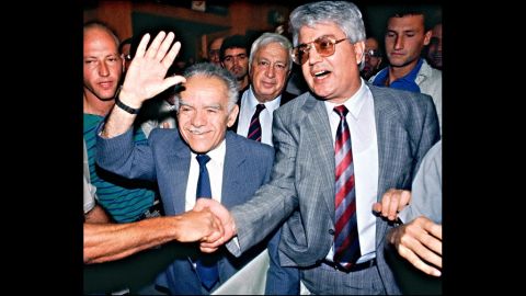 Shamir, left, waves to supporters July 5, 1989, in Tel Aviv as he and his two rivals, Ariel Sharon. center, and David Levy, right, walk in to address the Likud Central Committee. Shamir was military leader of the extremist Stern Gang between 1944 and 1946, and was behind a series of anti-British attacks, before Israel declared its independence in 1948. Shamir had withdrawn from public life over the past decade, silenced by Alzheimer's disease.