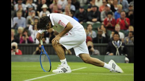 Cyprus's Marcos Baghdatis gets up after slipping during the fourth set of his third-round men's singles match against Britain's Andy Murray on Saturday.