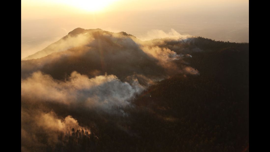 Smoke billows at sunrise from part of the Waldo Canyon fire in Colorado Springs.