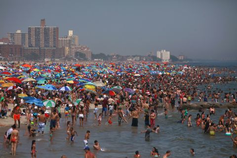 Residents crowd onto the beach at Coney Island in  Brooklyn, New York, in the powerful heat on Saturday.