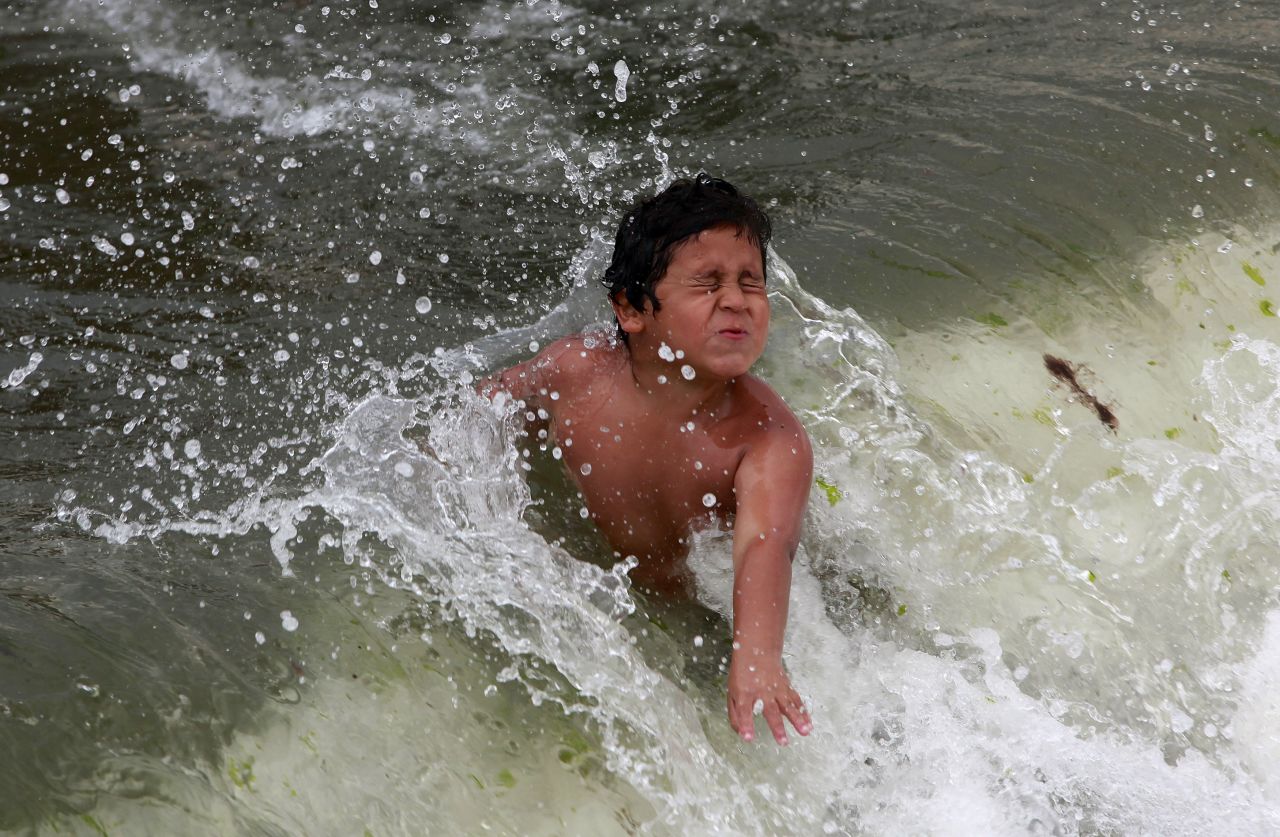 A boy plays in the ocean at Coney Island on Saturday.