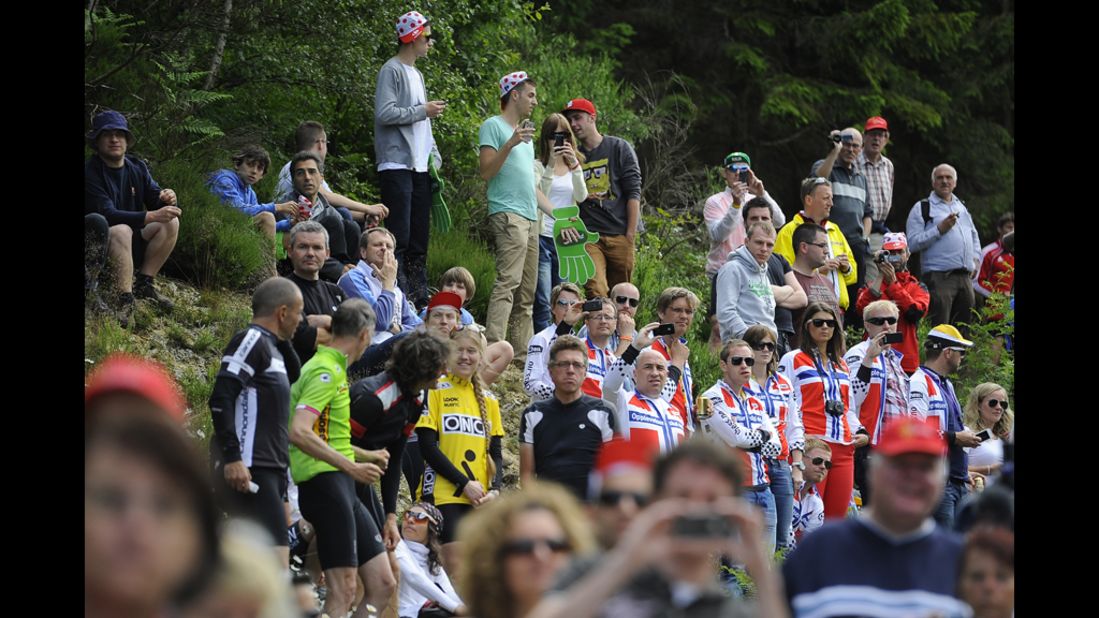 Fans wait on the roadside for the almost 200 riders to pass during Stage 1 on Sunday.