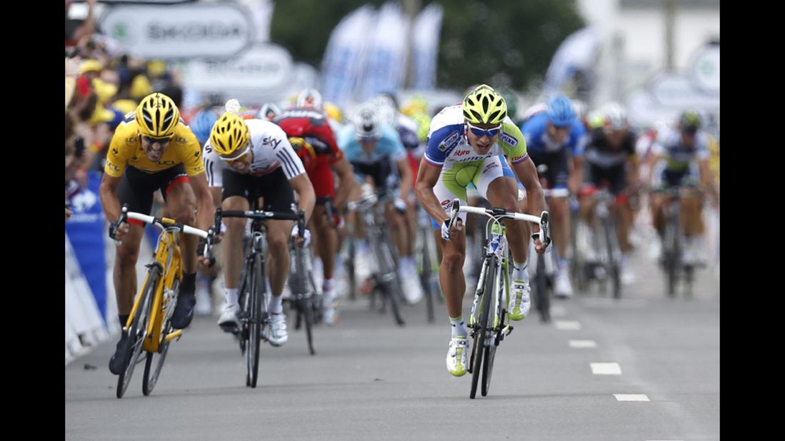 Peter Sagan of Slovakia, right, sprints to victory at the Stage 1 finish line Sunday ahead of Fabian Cancellara of Switzerland, left, and Edvald Boasson Hagen of Norway, center.