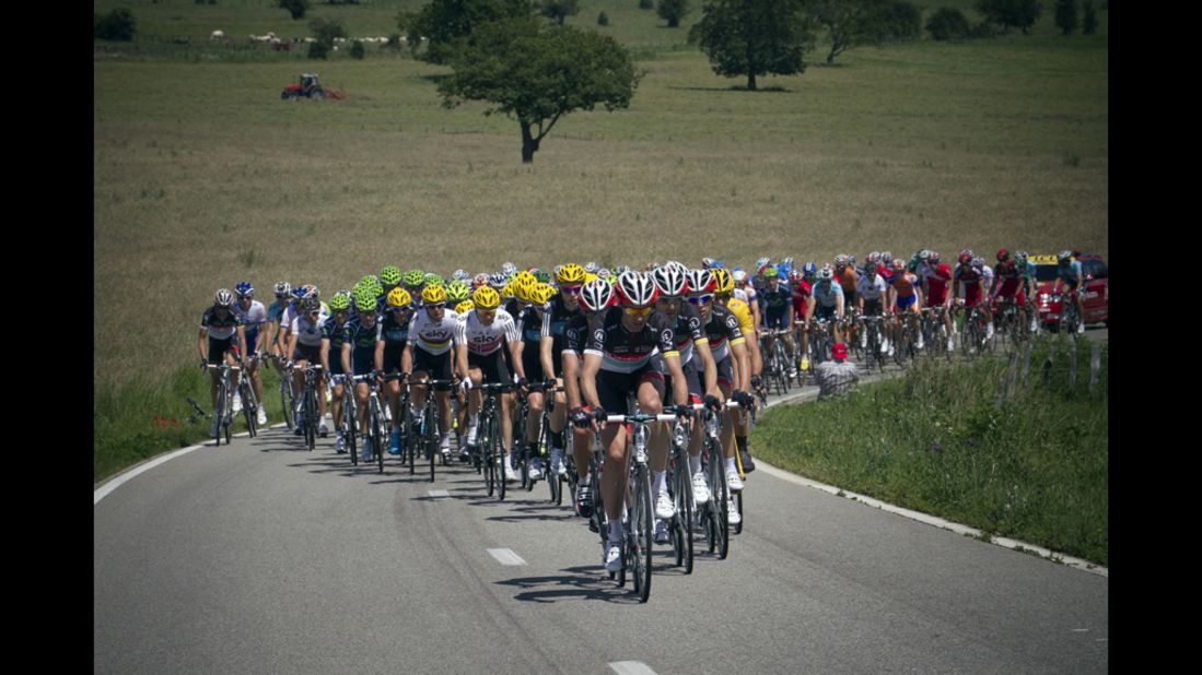 The peloton travels along a narrow road through the Belgian countryside on Sunday.