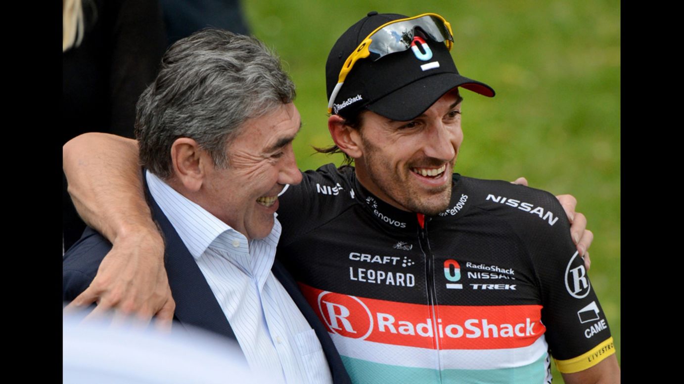 Overall race leader Cancellara embraces former Belgian cyclist Eddy Merckx after Sunday's stage.