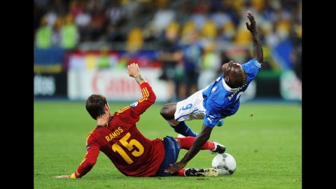 Spain's Sergio Ramos slides in to tackle Mario Balotelli of Italy.