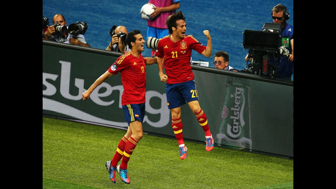 David Silva of Spain, right, celebrates with teammate Alvaro Arbeloa after scoring the opening goal against Italy.