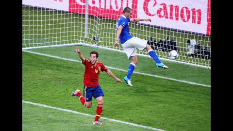 Jordi Alba of Spain celebrates after scoring his team's second goal as Leonardo Bonucci of Italy kicks the ball in frustration.