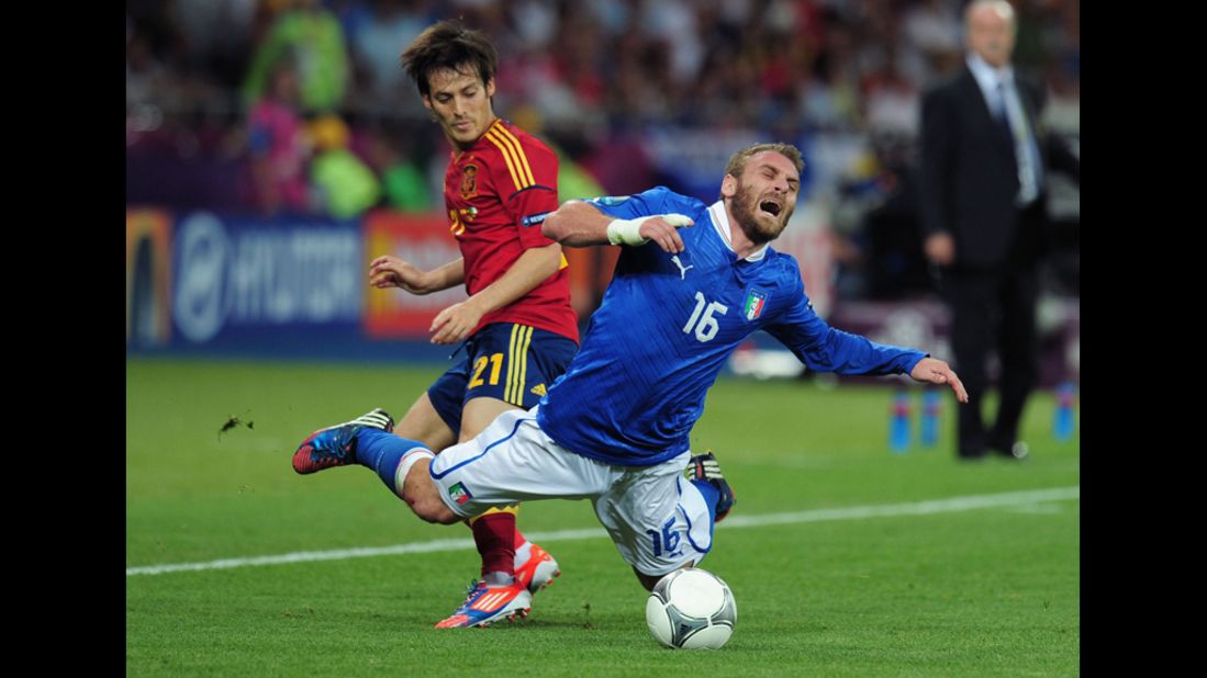 Daniele De Rossi of Italy falls to the ground Sunday after battling David Silva of Spain for the ball.