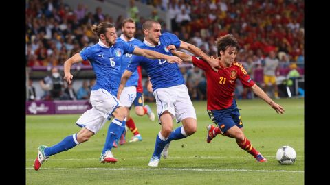 Federico Balzaretti, left, and  Leonardo Bonucci of Italy challenge Spain's David Silva during Sunday's final match.