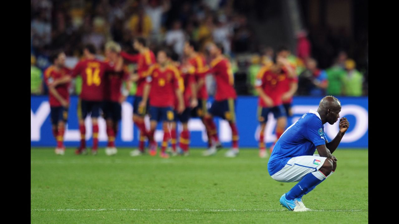 Italy's Mario Balotelli reacts to Spain's fourth and final goal in Sunday's match.