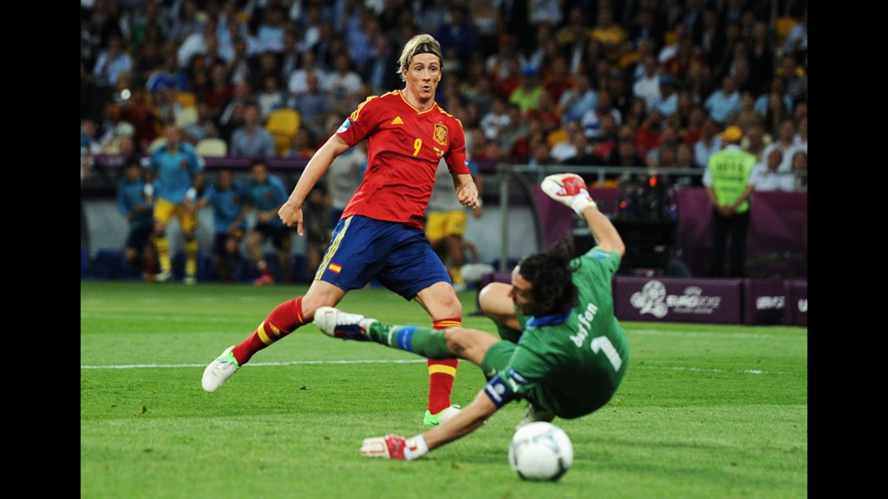  Spain's Fernando Torres nudges the ball toward the goal past Italy's Gianluigi Buffon.