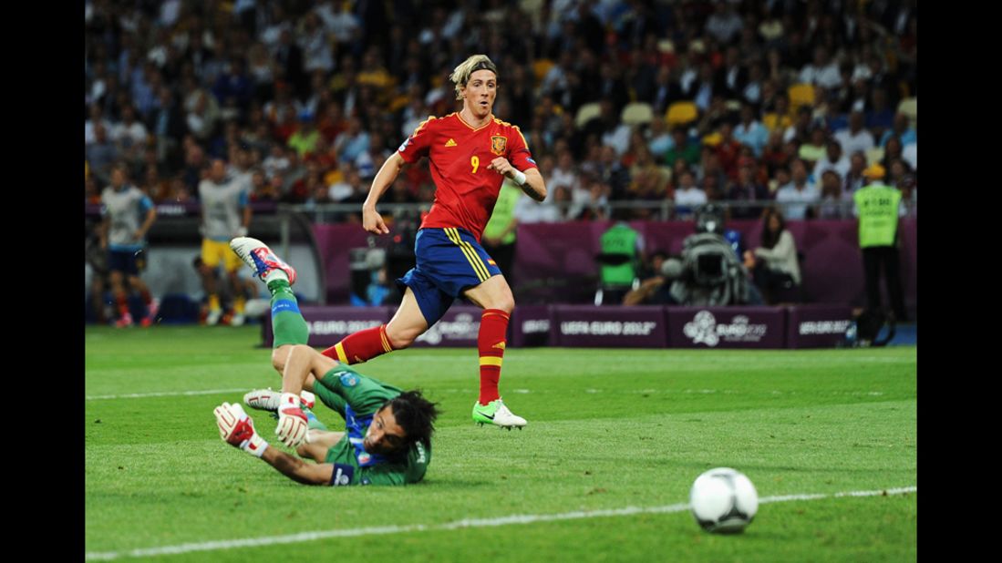 Gianluigi Buffon of Italy looks back at the ball as Spain's Fernando Torres scores.