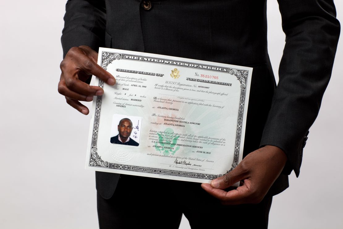 Stan Sowunmi of Nigeria displays his naturalization certificate after becoming a U.S. citizen.