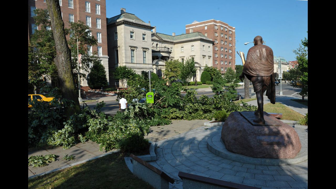 Tree branches lie near the statue of Mohandas K. Gandhi at Dupont Circle in Washington. The storms produced hurricane-force winds in excess of 80 mph.