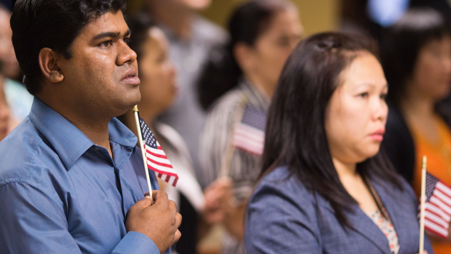 Newly naturalized Americans recite the Pledge of Allegiance at a recent ceremony in Atlanta.