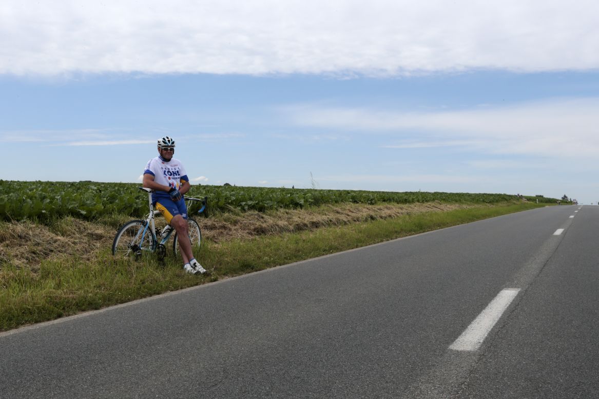 A spectator sits along the course Monday in Belgium, where Stage 2 of the race covers 129 miles from Vise to Tournai and is relatively flat.