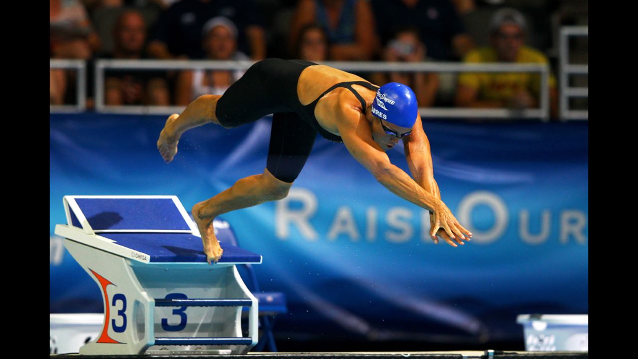Torres, 45, dives off of the starting block as she competes in the second semifinal heat of the Women's 50-meter Freestyle during Day Seven of the 2012 U.S. Olympic Swimming Team Trials on Sunday, July 1.