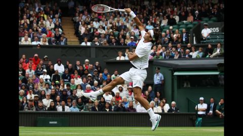 Roger Federer of Switzerland returns the ball to Xavier Malisse of Belgium during the fourth-round match at the Wimbledon championships in London on Monday.