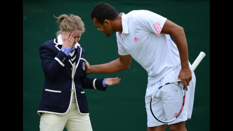 France's Jo-Wilfried Tsonga attends to a line judge who was hit in the face Monday by a ball during his fourth-round men's singles match against Mardy Fish of the U.S.