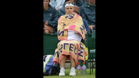 Russia's Maria Kirilenko keeps warm during a break in her match against China's Peng Shuai on Monday.