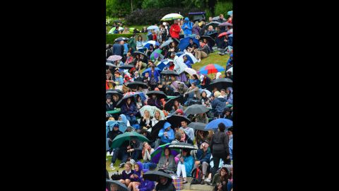 Rain and low temperatures set in again Monday at Wimbledon, delaying some matches and sending fans scurrying for cover.