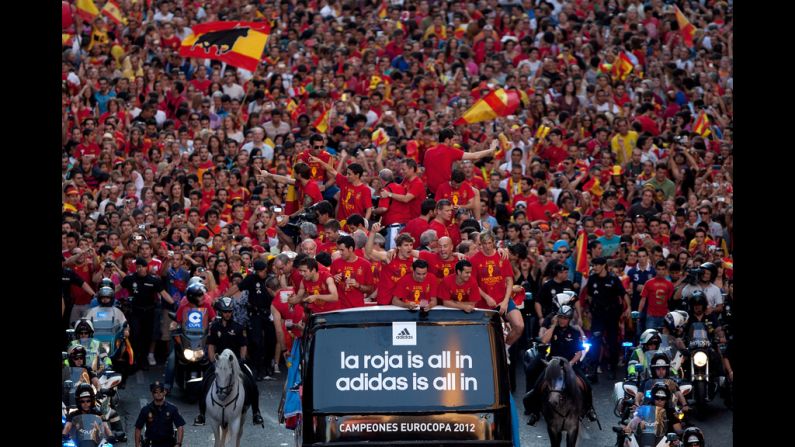 Spain's soccer team celebrates with the Euro 2012 trophy on a double-decker bus during the victory parade in Madrid on Monday. Spain defeated Italy 4-0 in the final match on Sunday. Euro 2012, bringing together 16 of Europe's best national soccer teams, began June 8 in Poland and Ukraine. Look back at the action and atmosphere.