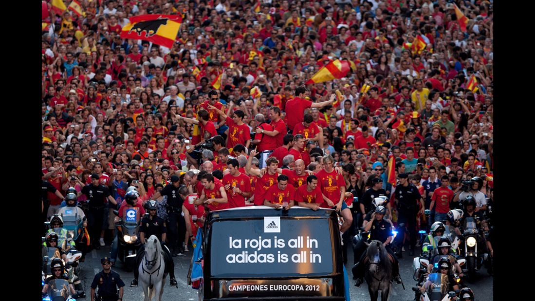 Spain's soccer team celebrates with the Euro 2012 trophy on a double-decker bus during the victory parade in Madrid on Monday. Spain defeated Italy 4-0 in the final match on Sunday. Euro 2012, bringing together 16 of Europe's best national soccer teams, began June 8 in Poland and Ukraine. Look back at the action and atmosphere.