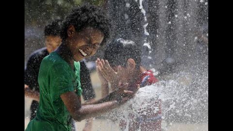 Aziz Taylor, 11, plays in a water fountain Monday in the Capitol Heights neighborhood of Washington.