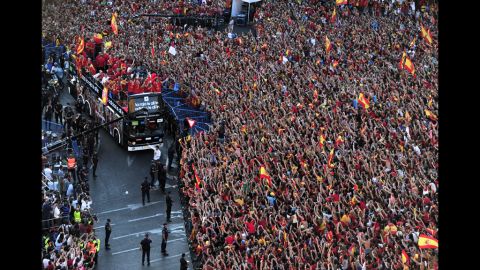 Spain's team arrives at Cibeles Square on top of a double-decker bus Monday after parading through Madrid.