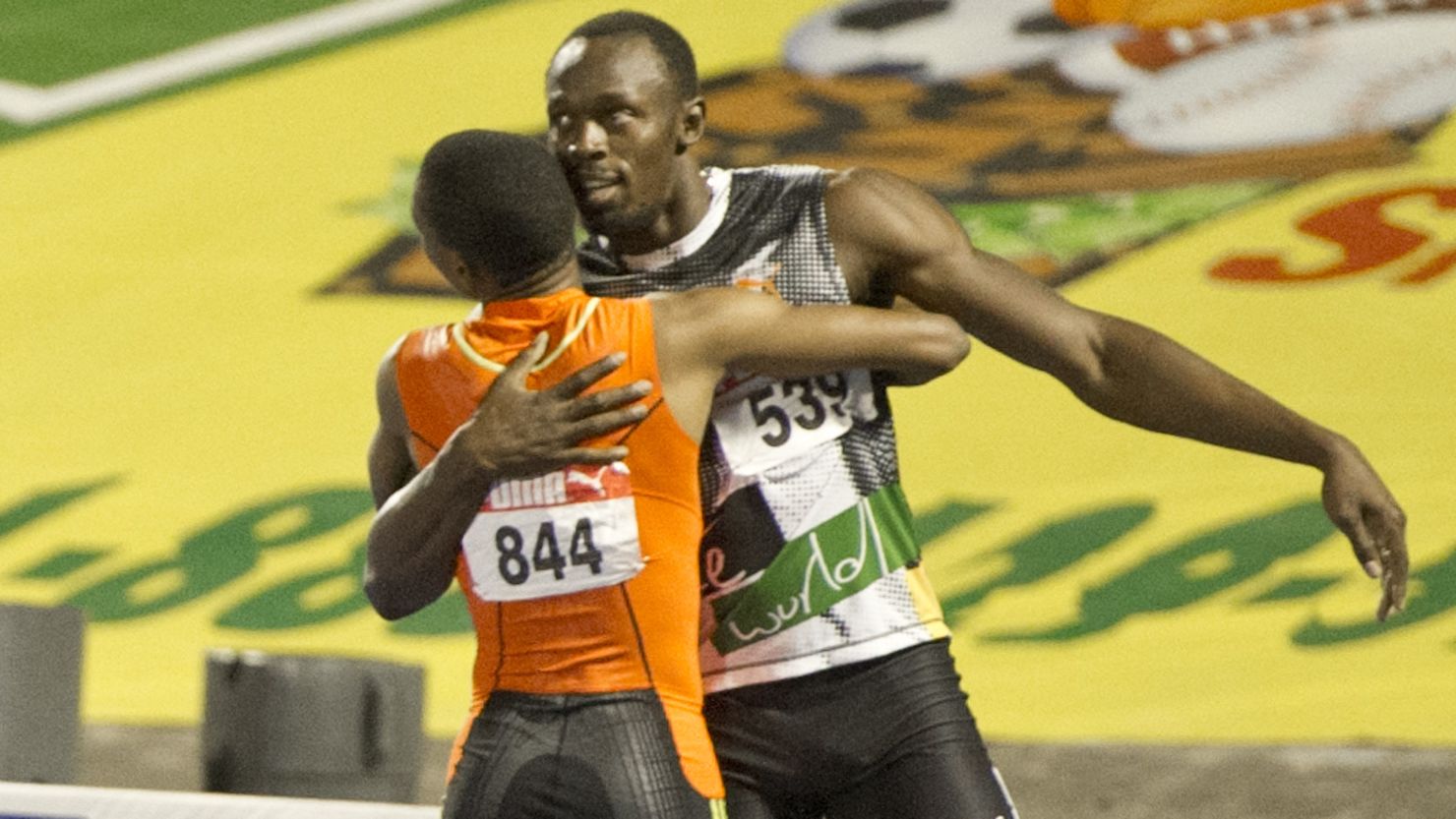 Sprinters Usain Bolt and Yohan Blake embrace after the latter clinched 200m victory at the Jamaican trials.