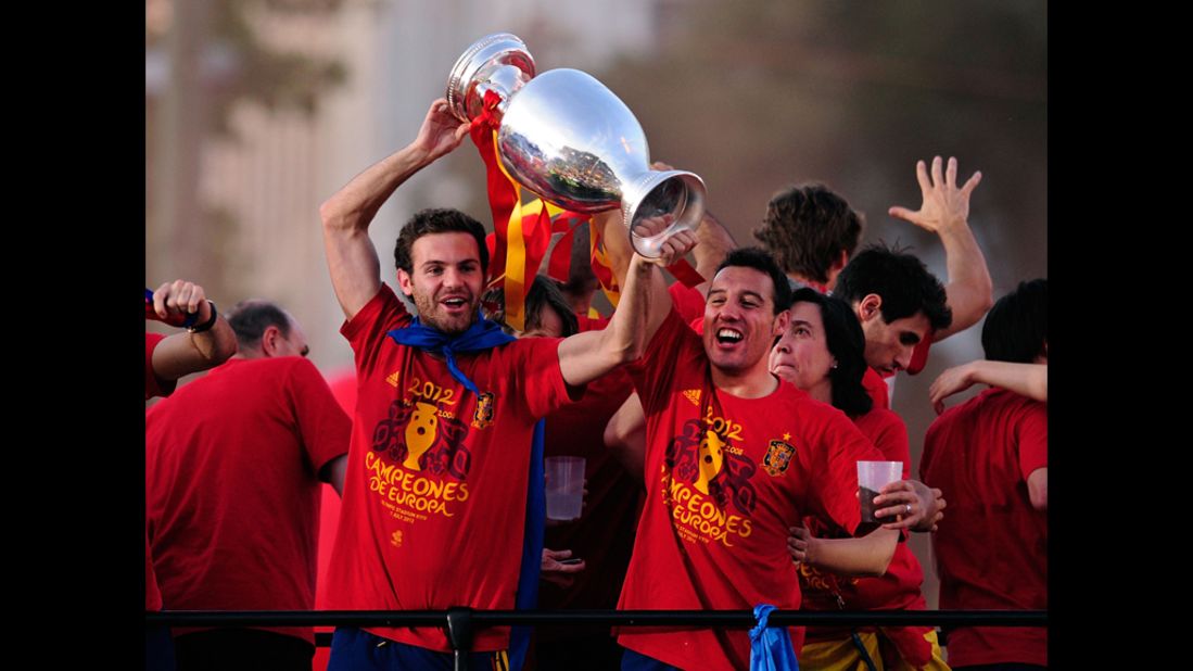 Juan Mata, left, and Santi Cazorla of Spain hoist the Euro 2012 trophy during Monday's celebrations.