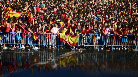 Fans celebrate in Cibeles Square during the victory parade. Organizers had the crowd cooled off with hoses.