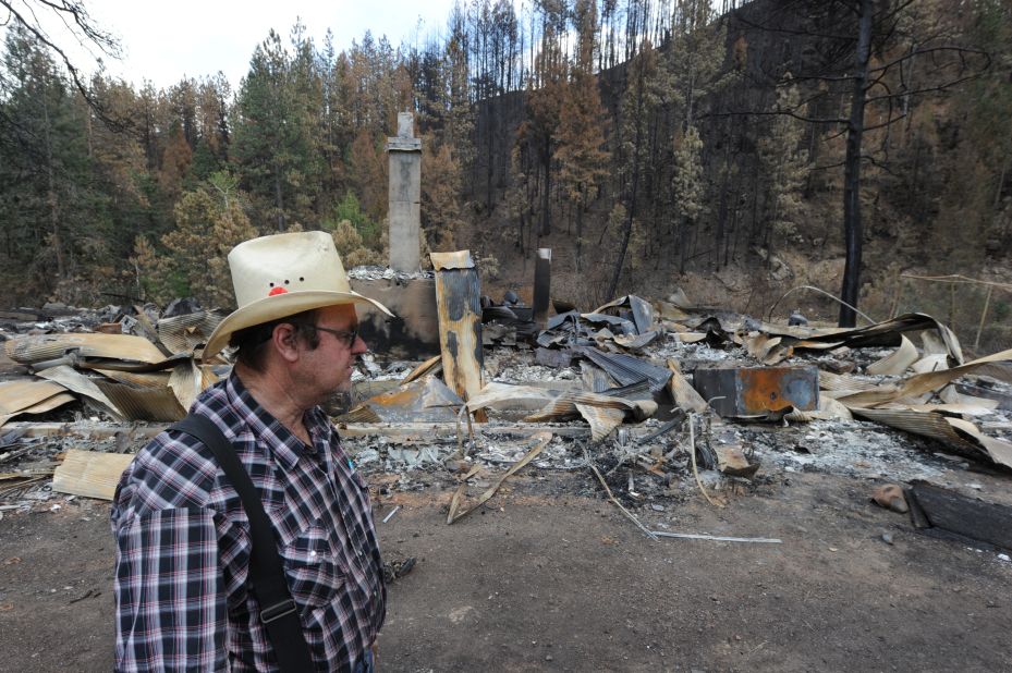Frank Baker visits the remains of his brother's home in Bellvue, Colorado, on Saturday, June 30. The house was burned to the ground in the High Park Fire.