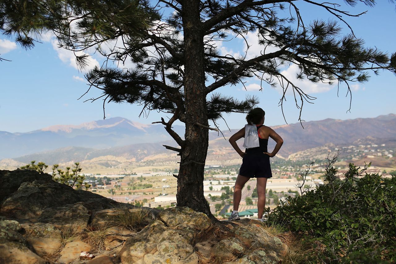 A jogger on Sunday looks out over neighborhoods in Colorado Springs that were evacuated due to the Waldo Canyon Fire. The massive fire has destroyed hundreds of homes and forced more than 32,000 people to flee.