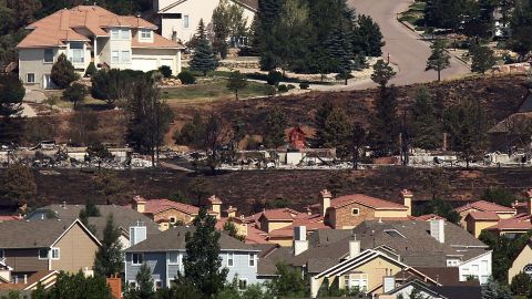 Fire-destroyed homes are seen in the Mountain Shadows neighborhood in Colorado Springs, where hundreds of residents were given an eight-hour window to visit their properties on Sunday, July 1.