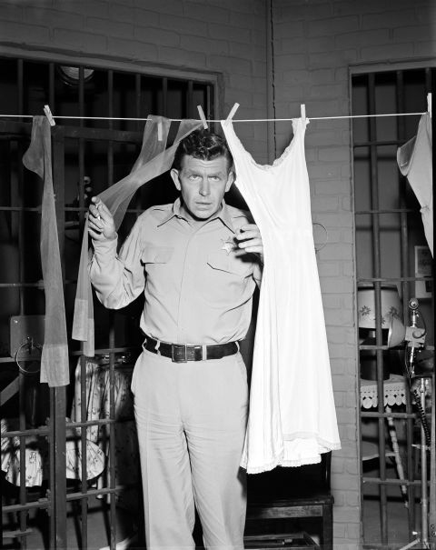 Griffith as Sheriff Andy Taylor peers through laundry in "Andy and the Woman Speeder."