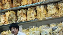  A file photo taken on November 22, 2011, shows a man inside a shark fin store in Hong Kong.