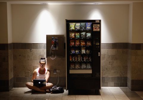Katie Kiang finds shelter from the heat to study for the Graduate Record Examinations inside an air-conditioned mall in Silver Spring, Maryland, on Monday. Kiang's home is one of the thousands without electricity after storms hit hard.