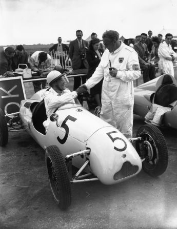 UK racing legend Stirling Moss, seen here talking to his father Alfred, competed at Silverstone as a 19-year-old that month.