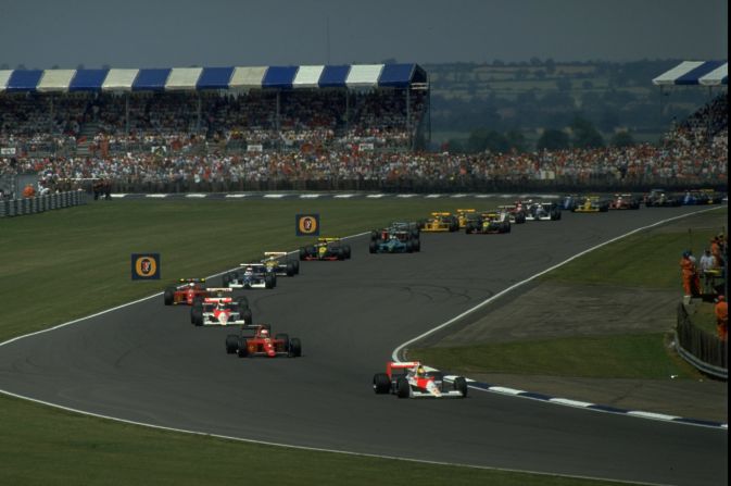 F1 legend Ayrton Senna leads the field during the first lap of the British Grand Prix in 1990, a year that major revisions were made to the circuit.