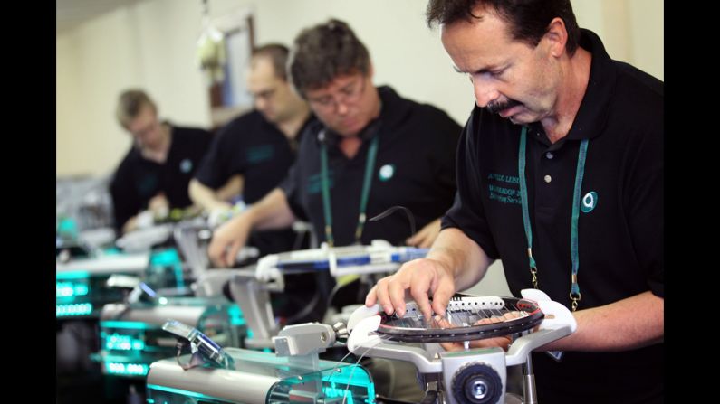 Workers re-string rackets for players at Wimbledon on Tuesday.